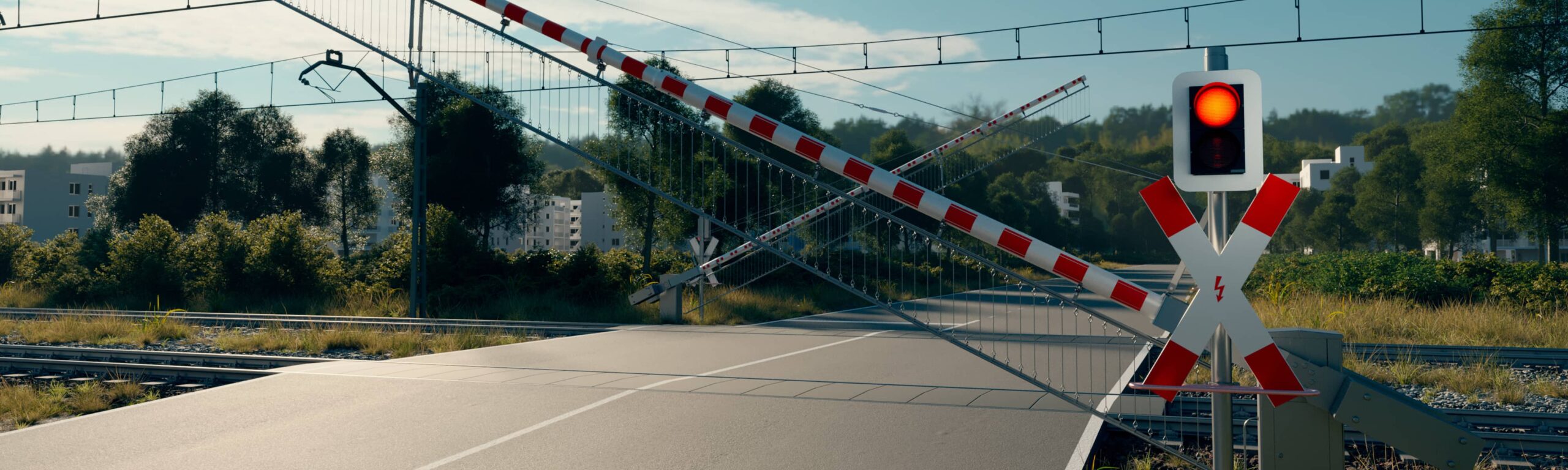 Geschlossene Schranken und rotes Signal sichern den Bahnübergang bei PINTSCH.